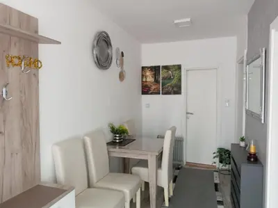 a dining room with a table and chairs at Apartmani NANA in Vrnjci