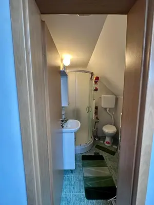 a small bathroom with a sink and a toilet at Chalet Pinecone - Ušuškan apartman, savršen za zimu i leto - Modern Mountain Retreat with Stunning View in Kopaonik