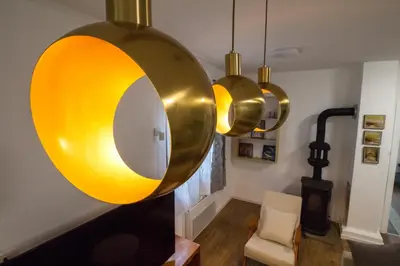 a room with a mirror and three pendant lights at Kuća Knjiga in Slavinja