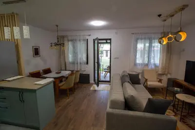 a living room with a couch and a table at Kuća Knjiga in Slavinja