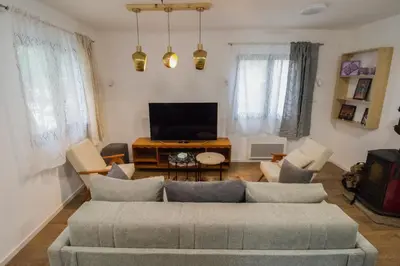 a living room with a couch and a tv at Kuća Knjiga in Slavinja