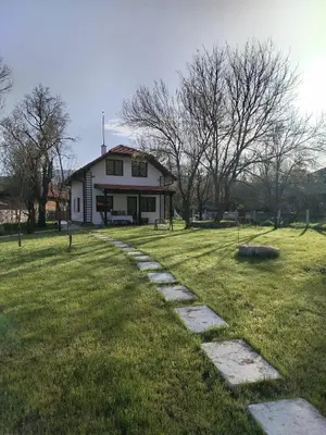 a stone path leading to a white house at Kuća Knjiga in Slavinja