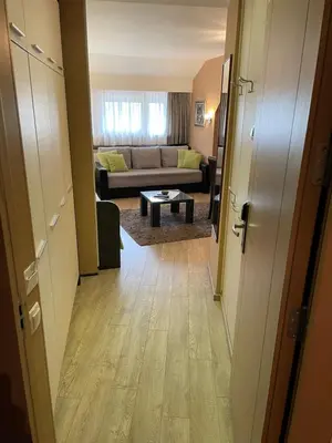 a hallway leading to a living room with a couch at Apartment Brvenik Plus in Kopaonik