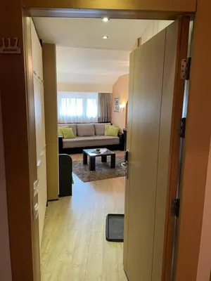 a living room with a couch and a table at Apartment Brvenik Plus in Kopaonik