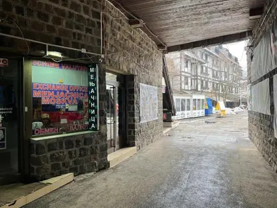 a brick building with a sign on the side of it at Apartment Brvenik Plus in Kopaonik