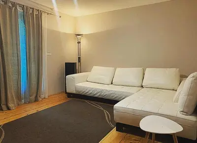 a living room with a couch and a table at Holiday Home Aleksandar Brzece Kopaonik in Brzeće