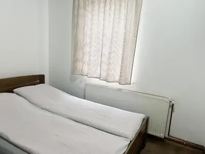 a small bed in a room with a window at Holiday Home Aleksandar Brzece Kopaonik in Brzeće