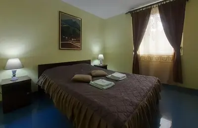 a bedroom with a bed with two pillows on it at Smeštaj Franica in Kuršumlija