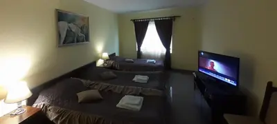a room with two beds and a television in it at Smeštaj Franica in Kuršumlija