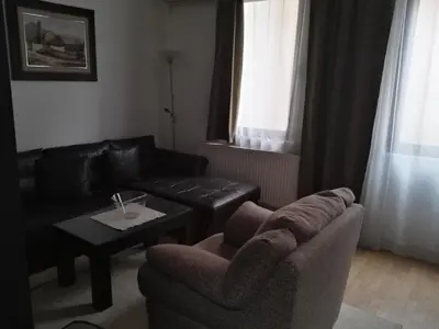 a living room with a couch and a coffee table at Guest House Amico in Vranje