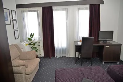 a living room with a desk with a computer and a chair at Guest House Amico in Vranje