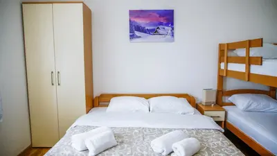 a bedroom with a bed with two towels on it at Apartment Petrović in Kopaonik