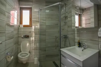 a bathroom with a toilet and a sink and a shower at Apartment Petrović in Kopaonik