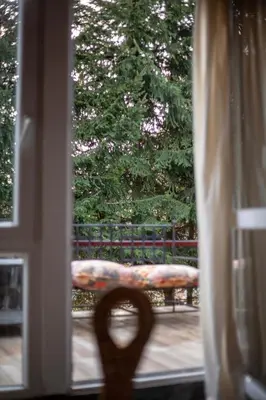 a view of a bench through a window at Holiday Cottage Pedja in Kopaonik