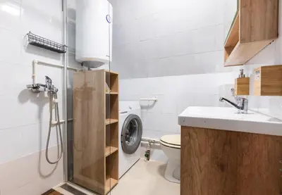 a bathroom with a shower and a toilet and a sink at Holiday Cottage Pedja in Kopaonik