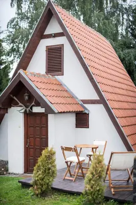 a small white cottage with a red roof at Holiday Cottage Pedja in Kopaonik
