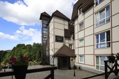 a building with a sign that says hotel at Apartment Planinska Carolija in Kopaonik