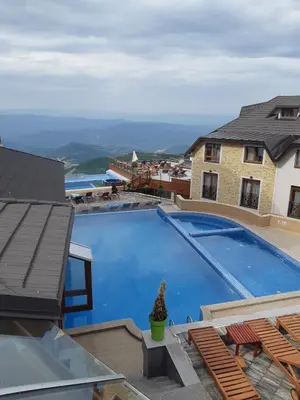 a large swimming pool sitting on top of a house at Apartment G10 Milmari resort in Kopaonik