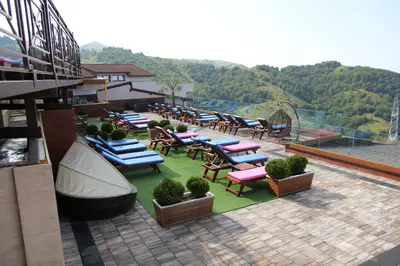 a group of chairs and tables on a patio at Apartment G10 Milmari resort in Kopaonik
