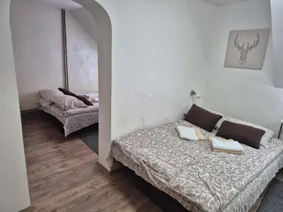 a small bedroom with a bed and a chair at Apartments Vila Djurdja in Kopaonik