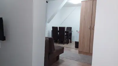 a living room with a couch and some chairs at Apartments Vila Djurdja in Kopaonik
