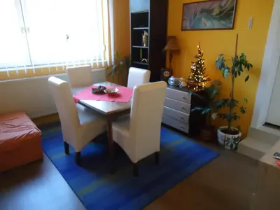 a dining room with a table and chairs and a christmas tree at Apartments Villa Svetlana in Vrnjačka Banja
