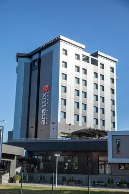 a large white building with a sign on it at Hotel Ana Lux Spa in Pirot