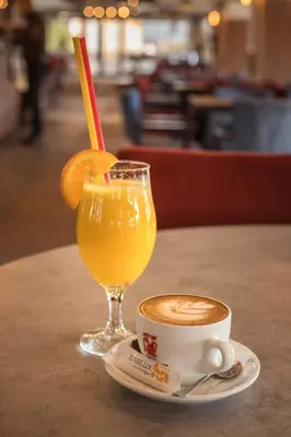 a cup of coffee and a glass of orange juice at Hotel Ana Lux Spa in Pirot