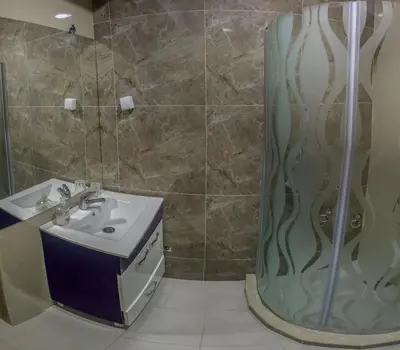 a bathroom with a sink and a shower at Hotel Bella Nella in Leskovac