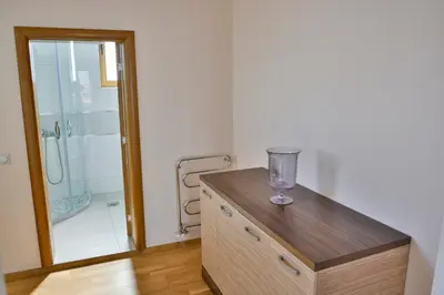 a bathroom with a glass bowl on a wooden dresser at Hotel Bella Nella in Leskovac