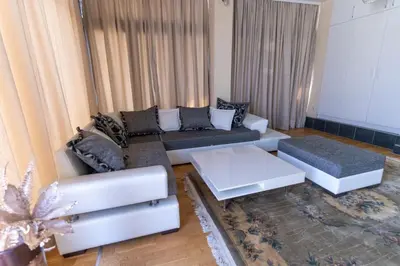 a living room with a couch and a coffee table at Hotel Bella Nella in Leskovac