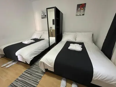 a bedroom with two beds and a mirror at Boulevard Apartments Cuprija in Ćuprija