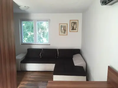 a living room with a couch and a window at Boulevard Apartments Cuprija in Ćuprija