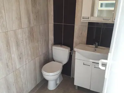 a bathroom with a toilet and a sink at Boulevard Apartments Cuprija in Ćuprija