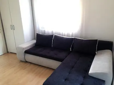 a couch in a living room with a window at Boulevard Apartments Cuprija in Ćuprija