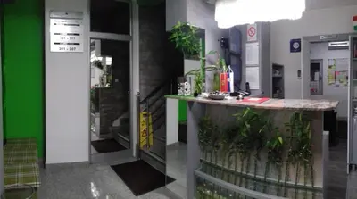 a lobby of a pharmacy with a counter with plants at Bed & Breakfast Park Gate in Vranje