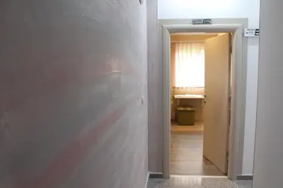 a room with a wall and a hallway with a door at Bed & Breakfast Park Gate in Vranje