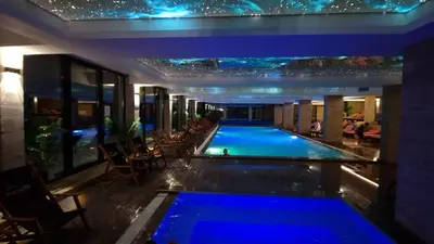 a swimming pool in the middle of a building at night at G4 Apartment Milmari in Kopaonik