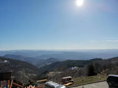 a view of the mountains from the top of a mountain at G4 Apartment Milmari in Kopaonik