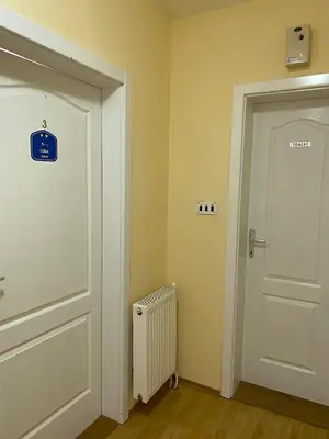 a room with a white door and a radiator at Guest House Trajkovic Jagodina in Jagodina