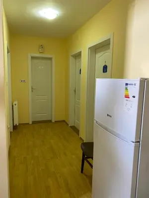 a kitchen with a white refrigerator in a room at Guest House Trajkovic Jagodina in Jagodina