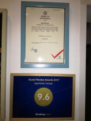 a sign for the entry to the greek revivalagencyagency awards apartment center at Apartman Centar in Kruševac
