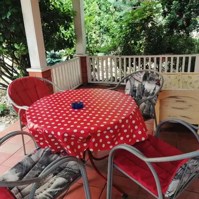 a red and white polka dot table and chairs on a porch at Apartman Centar in Kruševac