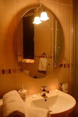 a bathroom with a sink and a large mirror at Love Apartment in Vrnjačka Banja