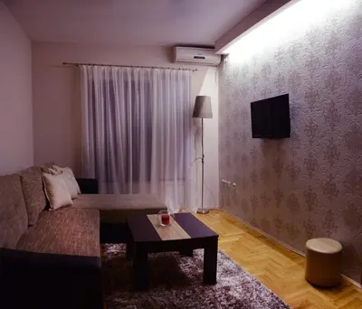 a living room with a couch and a table at Love Apartment in Vrnjačka Banja