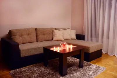 a living room with a couch and a coffee table at Love Apartment in Vrnjačka Banja