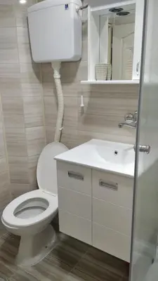 a bathroom with a white toilet and a sink at Apartman 4 - Studio Janja in Soko Banja