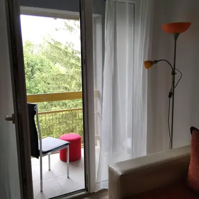 a room with a window with a chair and a lamp at Apartman 4 - Studio Janja in Soko Banja