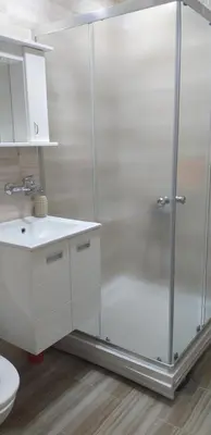 a shower with a glass door in a bathroom at Apartman 4 - Studio Janja in Soko Banja