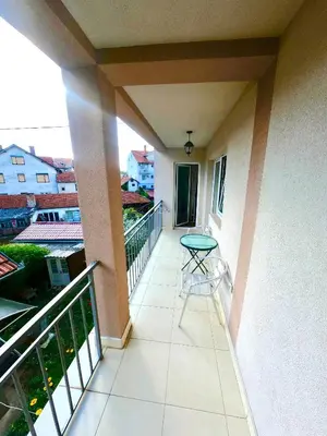 a balcony with a table and a view of a building at Filip Apartments in Soko Banja